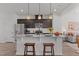 Open-concept kitchen with granite counters and stainless steel appliances with bar seating at 6415 Mentor Pl, Raleigh, NC 27616