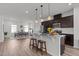 Open kitchen with granite counters, stainless steel appliances, and modern lighting at 6415 Mentor Pl, Raleigh, NC 27616