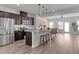 Spacious kitchen with a large island and stainless steel appliances flowing to the living area at 6415 Mentor Pl, Raleigh, NC 27616