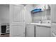 Laundry room with a washer, dryer, storage shelves, and tile flooring at 6415 Mentor Pl, Raleigh, NC 27616