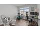 Home office with large window, two desks, and a comfortable chair and glider at 6415 Mentor Pl, Raleigh, NC 27616
