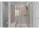 Glass shower enclosure with tiled walls, multiple shower heads, and a built in seat at 6415 Mentor Pl, Raleigh, NC 27616