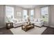 Bright and airy living room with large windows, neutral walls, comfortable sofas, and stylish decor at 700 Tambor Rd, Durham, NC 27713