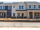 New townhomes featuring modern design and inviting entryways with brick accents at 717 Chandler Stone Dr, Zebulon, NC 27597
