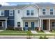 Charming townhome showcasing a covered entryway, low-maintenance landscaping, and a welcoming blue front door at 717 Chandler Stone Dr, Zebulon, NC 27597
