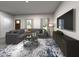 Cozy living room with comfortable seating, modern rug, and large screen television at 717 Chandler Stone Dr, Zebulon, NC 27597