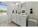 Stylish bathroom with a double sink vanity and an abundance of light from a window at 719 Chandler Stone Dr, Zebulon, NC 27597