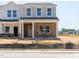 Charming two-story home with brick facade, covered porch, and neutral color palette at 719 Chandler Stone Dr, Zebulon, NC 27597