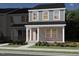 Inviting two-story home featuring a brick facade, covered porch, and landscaped yard at 719 Chandler Stone Dr, Zebulon, NC 27597