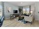 Bright living room featuring modern furniture, a large TV, and a decorative area rug at 719 Chandler Stone Dr, Zebulon, NC 27597