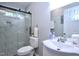 Bathroom featuring a glass shower, toilet, and sink at 722 Orchard Dr, Graham, NC 27253