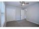 Clean bedroom with a ceiling fan, new carpet, a double closet, and a doorway to another room at 722 Orchard Dr, Graham, NC 27253