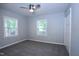 Serene bedroom with two windows providing natural light, neutral carpet, and a double closet at 722 Orchard Dr, Graham, NC 27253