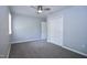 This bedroom has neutral carpet, a ceiling fan, and a closet at 722 Orchard Dr, Graham, NC 27253
