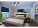 Stylishly staged bedroom with natural light, neutral tones, ceiling fan, and a modern bed frame at 722 Orchard Dr, Graham, NC 27253