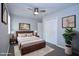 Staged bedroom with stylish lighting, neutral tones, ceiling fan, and a modern bed frame at 722 Orchard Dr, Graham, NC 27253