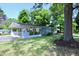 Charming single-story home featuring a carport, a well-maintained lawn, and a mature tree at 722 Orchard Dr, Graham, NC 27253