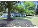 A cozy home surrounded by beautiful mature magnolia and maple trees at 722 Orchard Dr, Graham, NC 27253