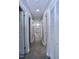 Bright hallway with gray vinyl plank flooring and white trim throughout at 722 Orchard Dr, Graham, NC 27253