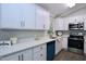Beautiful kitchen with white cabinetry, quartz countertops, and modern stainless steel appliances at 722 Orchard Dr, Graham, NC 27253