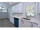 Well-lit kitchen features white cabinets, modern countertops and stainless steel appliances at 722 Orchard Dr, Graham, NC 27253