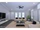 Bright, staged living room with modern finishes, neutral furniture and a ceiling fan at 722 Orchard Dr, Graham, NC 27253