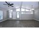 Bright living room with vaulted ceilings, wood floors, and abundant natural light from multiple windows at 722 Orchard Dr, Graham, NC 27253