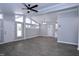 Spacious living room featuring vaulted ceilings, gray flooring, and natural light from multiple windows at 722 Orchard Dr, Graham, NC 27253