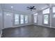 Bright living room with gray vinyl floors, neutral paint, and lots of natural light at 722 Orchard Dr, Graham, NC 27253