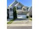 Charming townhome featuring a two-car garage, neutral siding, and manicured lawn at 7241 Terregles Dr, Raleigh, NC 27617