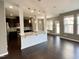 Open-concept living space with hardwood floors seamlessly connecting the kitchen at 7241 Terregles Dr, Raleigh, NC 27617