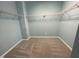 A walk-in closet with carpet flooring and wire shelving offers ample storage space at 7241 Terregles Dr, Raleigh, NC 27617