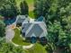 Aerial view of home with a landscaped yard, circular drive, and mature trees for added privacy on the property at 801 Pinehurst Dr, Chapel Hill, NC 27517