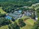 Aerial view of home next to the golf course, tennis courts, pool and country club for desirable amenities at 801 Pinehurst Dr, Chapel Hill, NC 27517