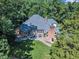 Stunning aerial view of the home showcasing the well-manicured lawn, brick exterior, and outdoor living space at 801 Pinehurst Dr, Chapel Hill, NC 27517