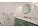 Cozy bathroom featuring a marble countertop vanity, round mirror, and brass fixtures at 801 Pinehurst Dr, Chapel Hill, NC 27517