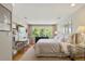 Spacious bedroom with a desk, queen sized bed, and large windows overlooking the trees at 801 Pinehurst Dr, Chapel Hill, NC 27517