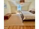 Sunlit bedroom showcasing hardwood floors and a comfy bed with white linens, complete with colorful light fixture at 801 Pinehurst Dr, Chapel Hill, NC 27517