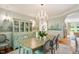 Elegant dining room featuring a crystal chandelier, muraled walls, and hardwood floors at 801 Pinehurst Dr, Chapel Hill, NC 27517