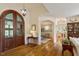 Grand foyer featuring hardwood floors, arched doorways, and elegant lighting fixtures at 801 Pinehurst Dr, Chapel Hill, NC 27517