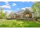 Charming brick home with a covered front porch, manicured lawn, and inviting curb appeal at 801 Pinehurst Dr, Chapel Hill, NC 27517