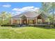 Charming brick home featuring a welcoming front porch with beautiful columns and manicured landscaping at 801 Pinehurst Dr, Chapel Hill, NC 27517