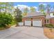 Detached two-car garage with white doors and a paved driveway at 801 Pinehurst Dr, Chapel Hill, NC 27517