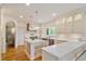 Elegant kitchen with a marble island, stainless steel appliances, and custom cabinets at 801 Pinehurst Dr, Chapel Hill, NC 27517