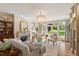 Bright living room with a fireplace, hardwood floors, and French doors leading to the yard at 801 Pinehurst Dr, Chapel Hill, NC 27517
