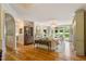 Elegant living room with hardwood floors, a fireplace, and large windows overlooking the backyard at 801 Pinehurst Dr, Chapel Hill, NC 27517