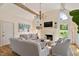 Open-concept living room with a vaulted ceiling, fireplace, and hardwood floors at 801 Pinehurst Dr, Chapel Hill, NC 27517