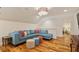 Bright living room with hardwood floors, recessed lighting, and a cozy blue couch with colorful pillows at 801 Pinehurst Dr, Chapel Hill, NC 27517