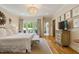 This main bedroom has a large window with backyard views, a decorative chandelier and hardwood flooring at 801 Pinehurst Dr, Chapel Hill, NC 27517