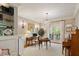 This well-lit office space offers custom shelving, a decorative chandelier, and glass doors to a balcony at 801 Pinehurst Dr, Chapel Hill, NC 27517
